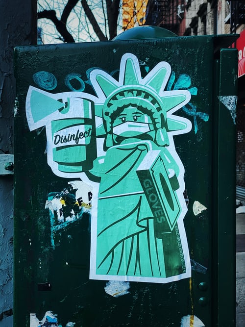 Statue of Liberty with face mask and sanitizer