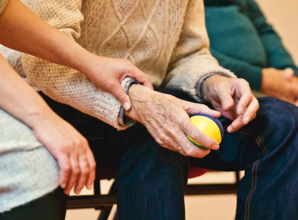 Older man holding a ball