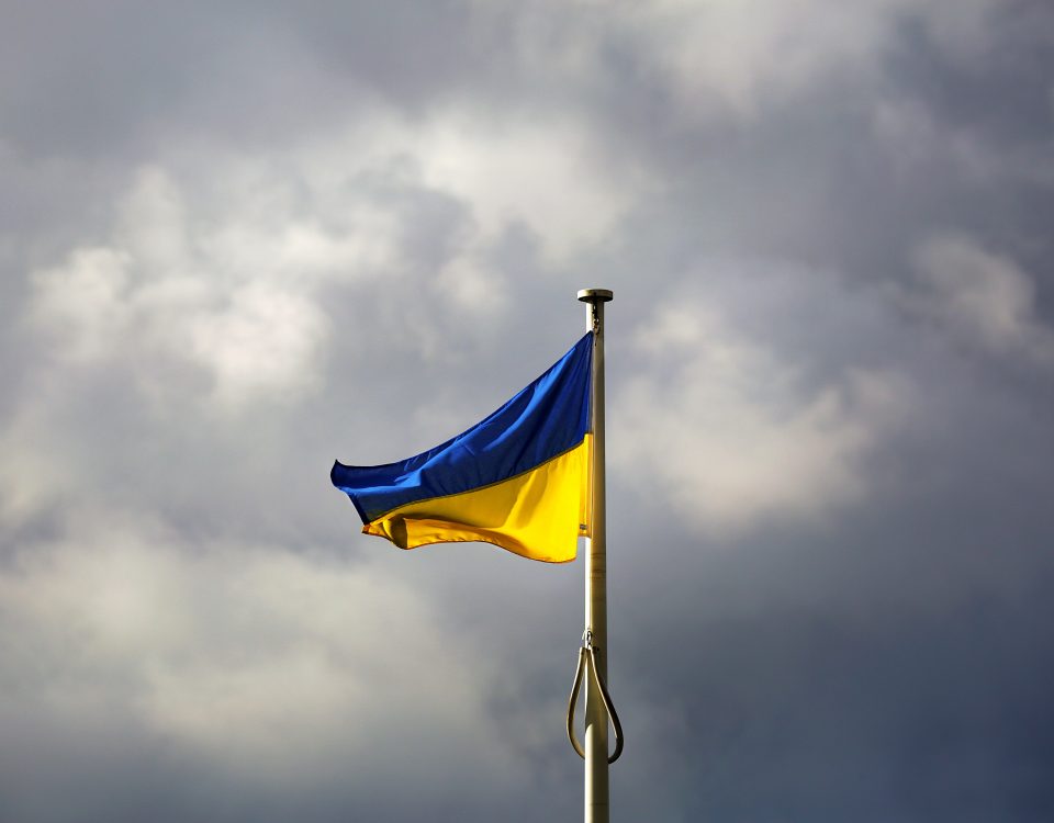 Flag of Ukraine flying against cloudy sky